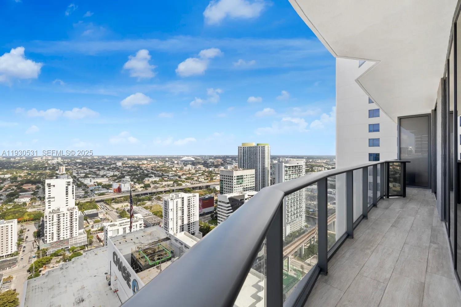 55 Southwest 9th Street, Unit 3806 Miami, FL 33130 - Photo 22 of 24 a view of a balcony with city