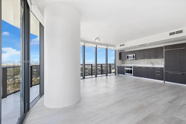a view of kitchen with a sink and chairs