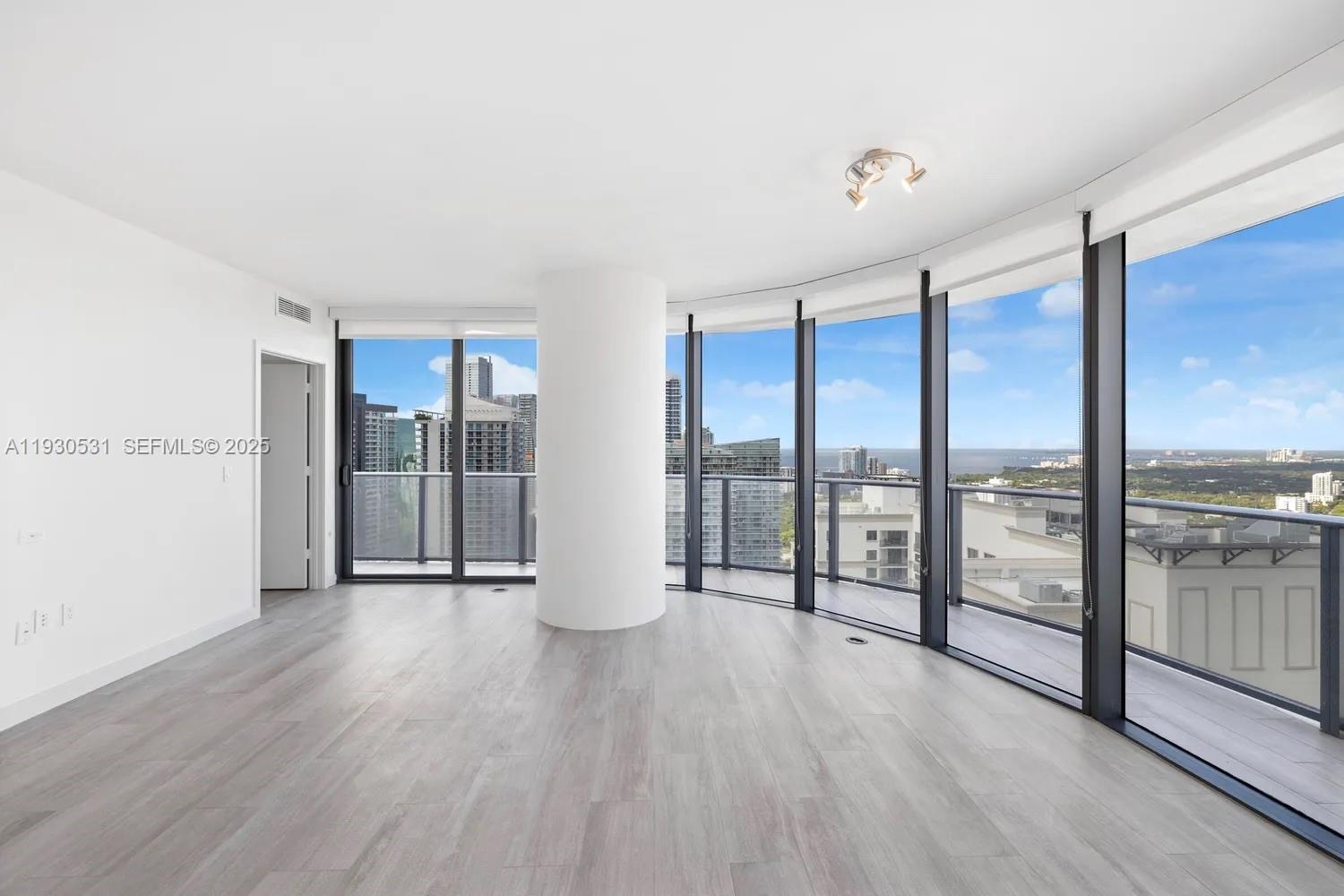 55 Southwest 9th Street, Unit 3806 Miami, FL 33130 - Photo 4 of 24 a view of an empty room and glass door