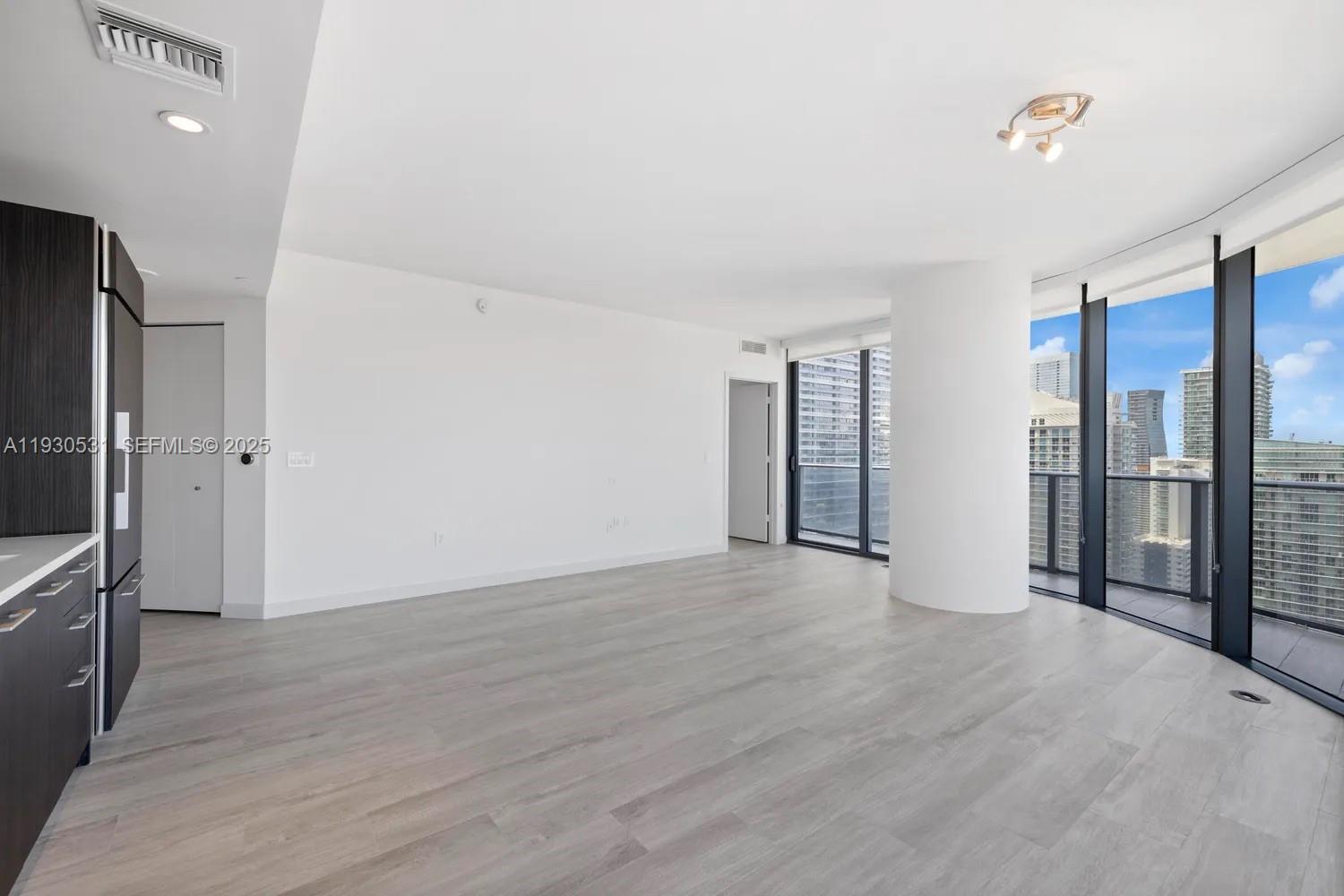 55 Southwest 9th Street, Unit 3806 Miami, FL 33130 - Photo 7 of 24 a view of an empty room with a window