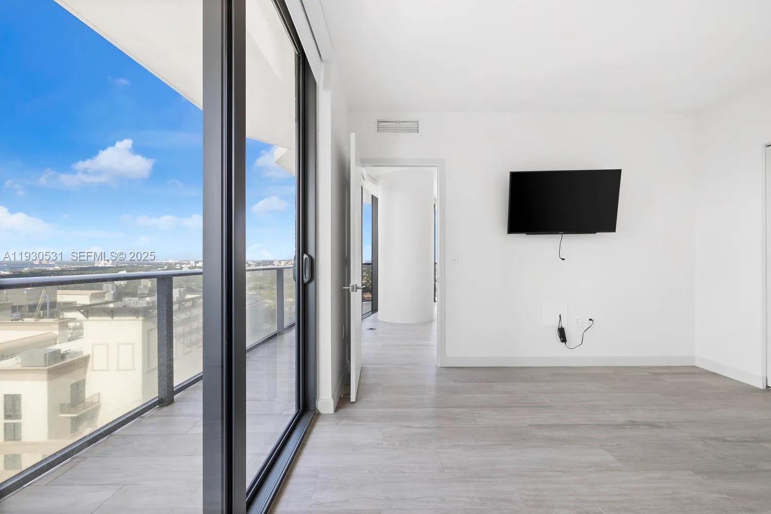 55 Southwest 9th Street, Unit 3806 Miami, FL 33130 - Photo 8 of 24 a view of a livingroom with an empty space and a window