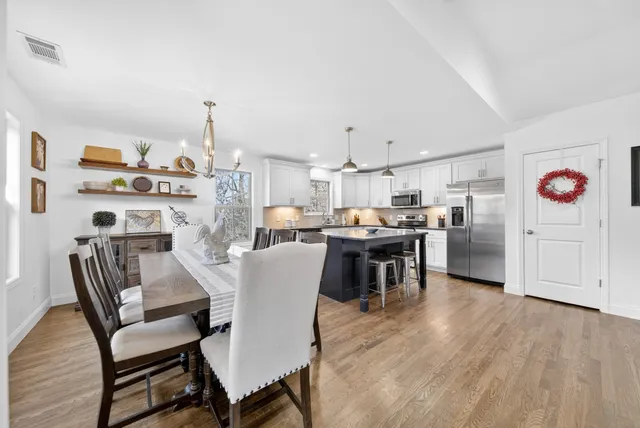 a large kitchen with stainless steel appliances granite countertop a stove oven and a refrigerator