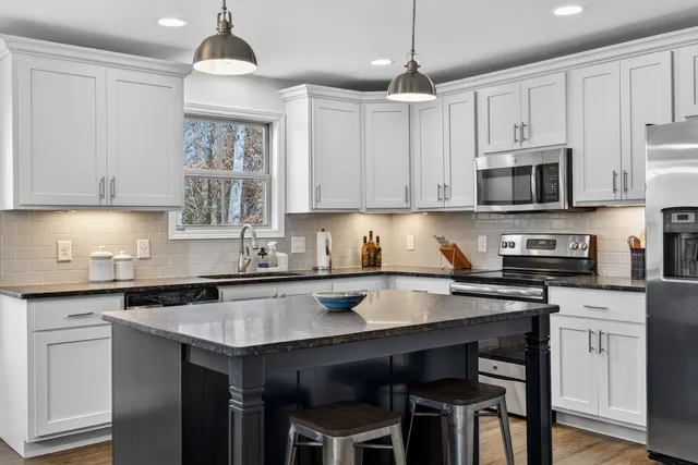 a stove top oven sitting inside of a kitchen