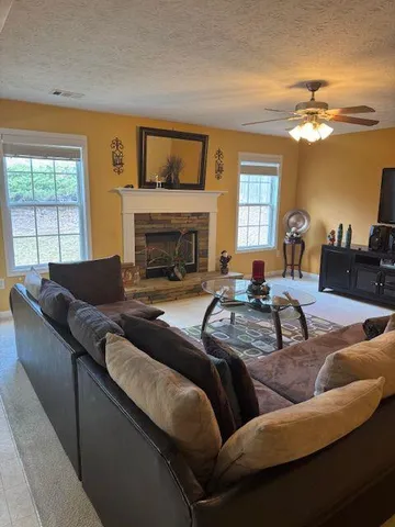 a living room with furniture and a fireplace