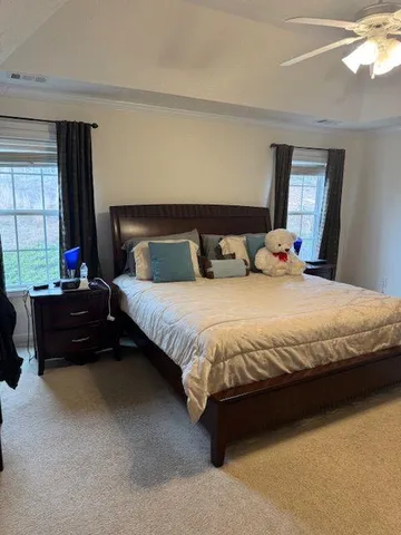 a bedroom with a bed and a couch