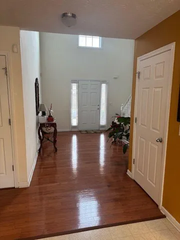 a view of a hallway view with wooden floor and furniture