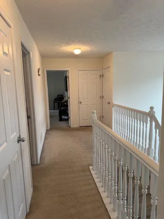 a view of a hallway view with staircase