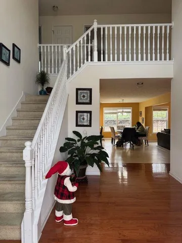a view of entryway livingroom and hall with wooden floor