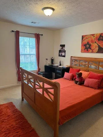 a bed room with two bed and a window