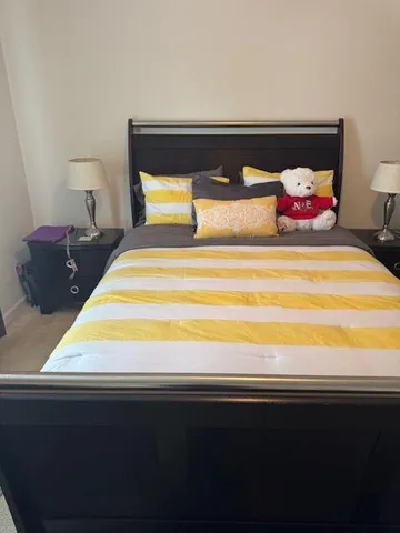 a bedroom with a bed and window