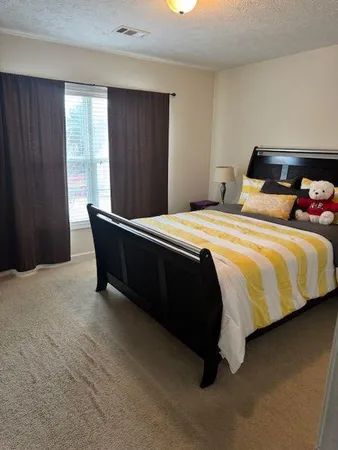 a bedroom with a bed and window