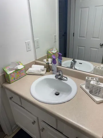 a bathroom with a sink and a mirror