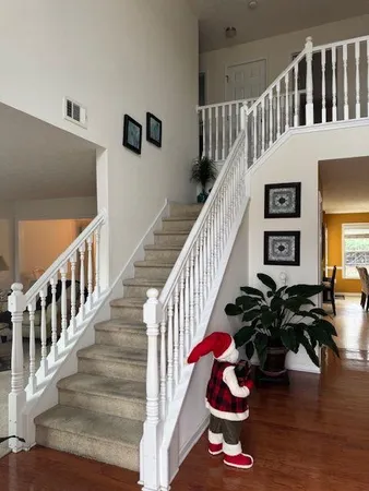 a view of entryway livingroom and hall with wooden floor