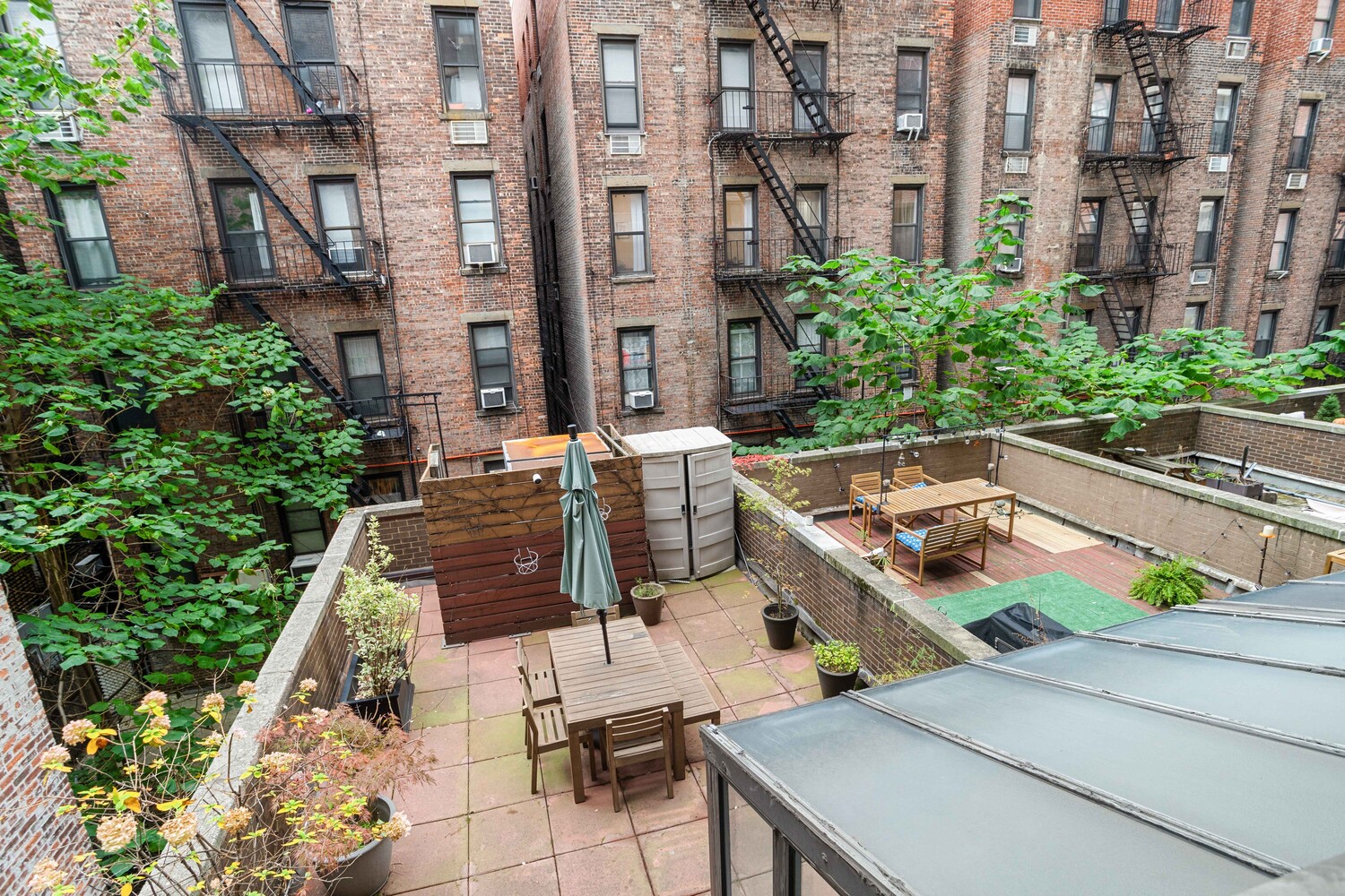 225 East 86th Street, Unit 204 Manhattan, NY 10028 - Photo 15 of 17 a view of a patio with couches table and chairs and potted plants