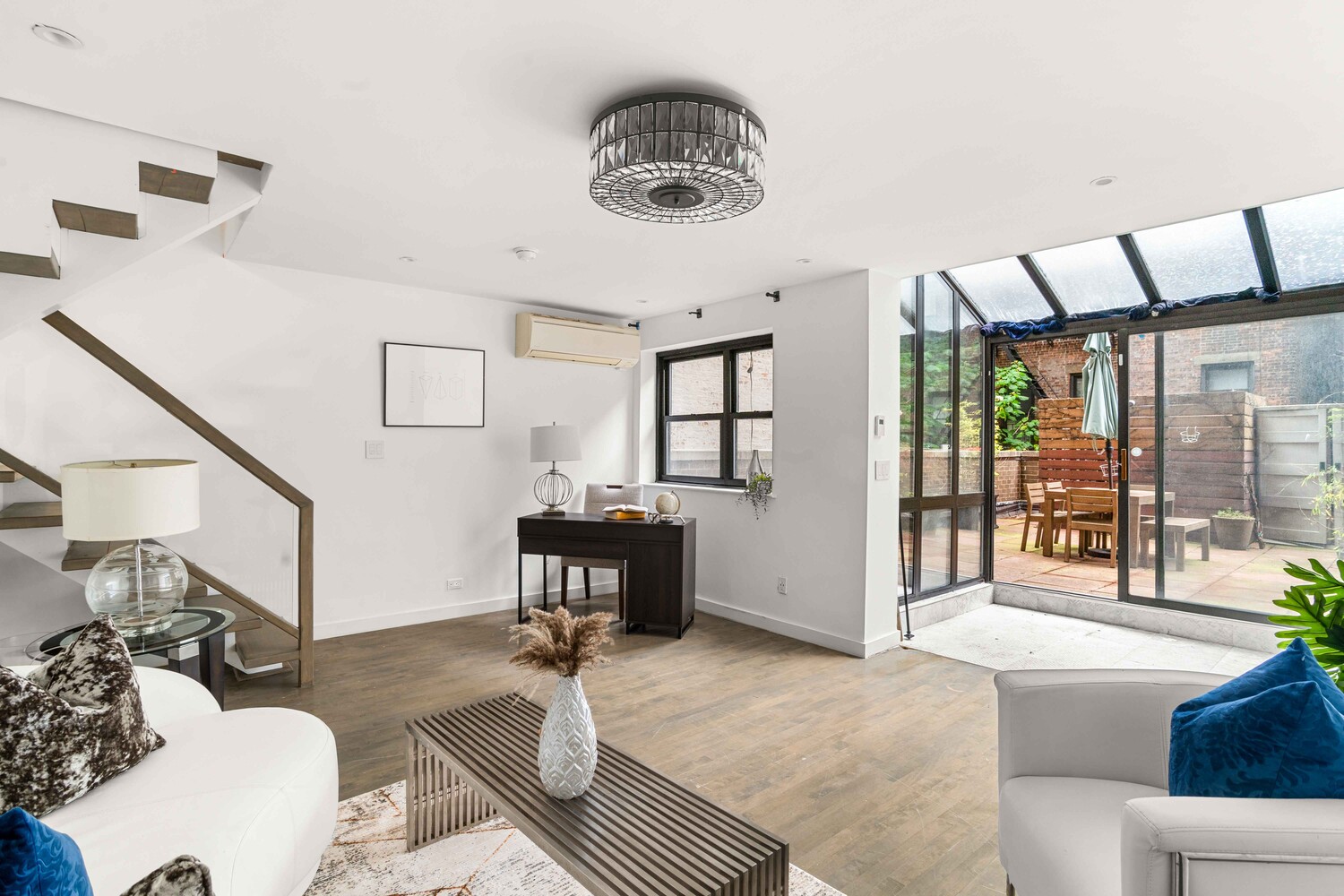 225 East 86th Street, Unit 204 Manhattan, NY 10028 - Photo 4 of 17 a living room with furniture and a window