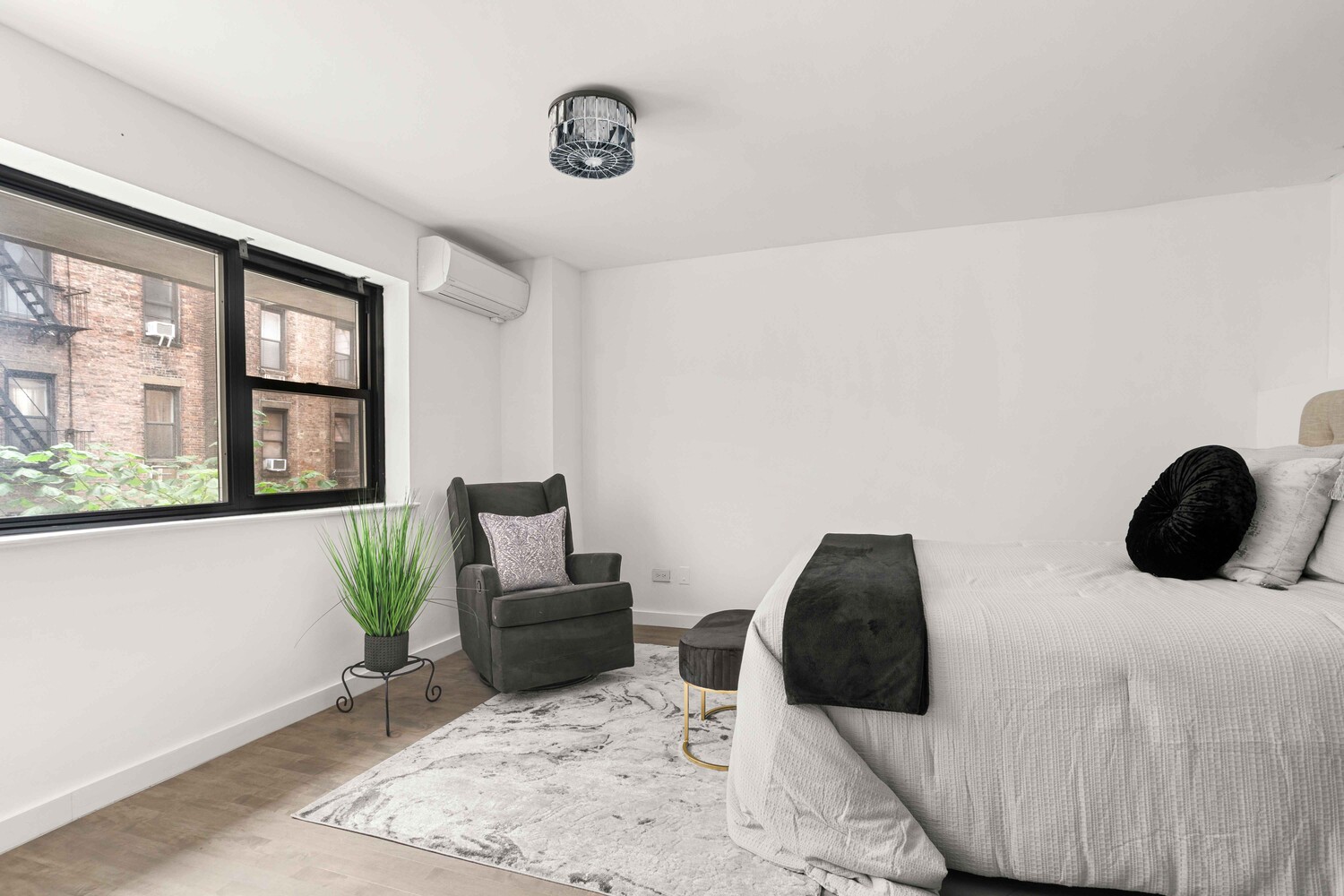 225 East 86th Street, Unit 204 Manhattan, NY 10028 - Photo 6 of 17 a bedroom with a bed and a large window