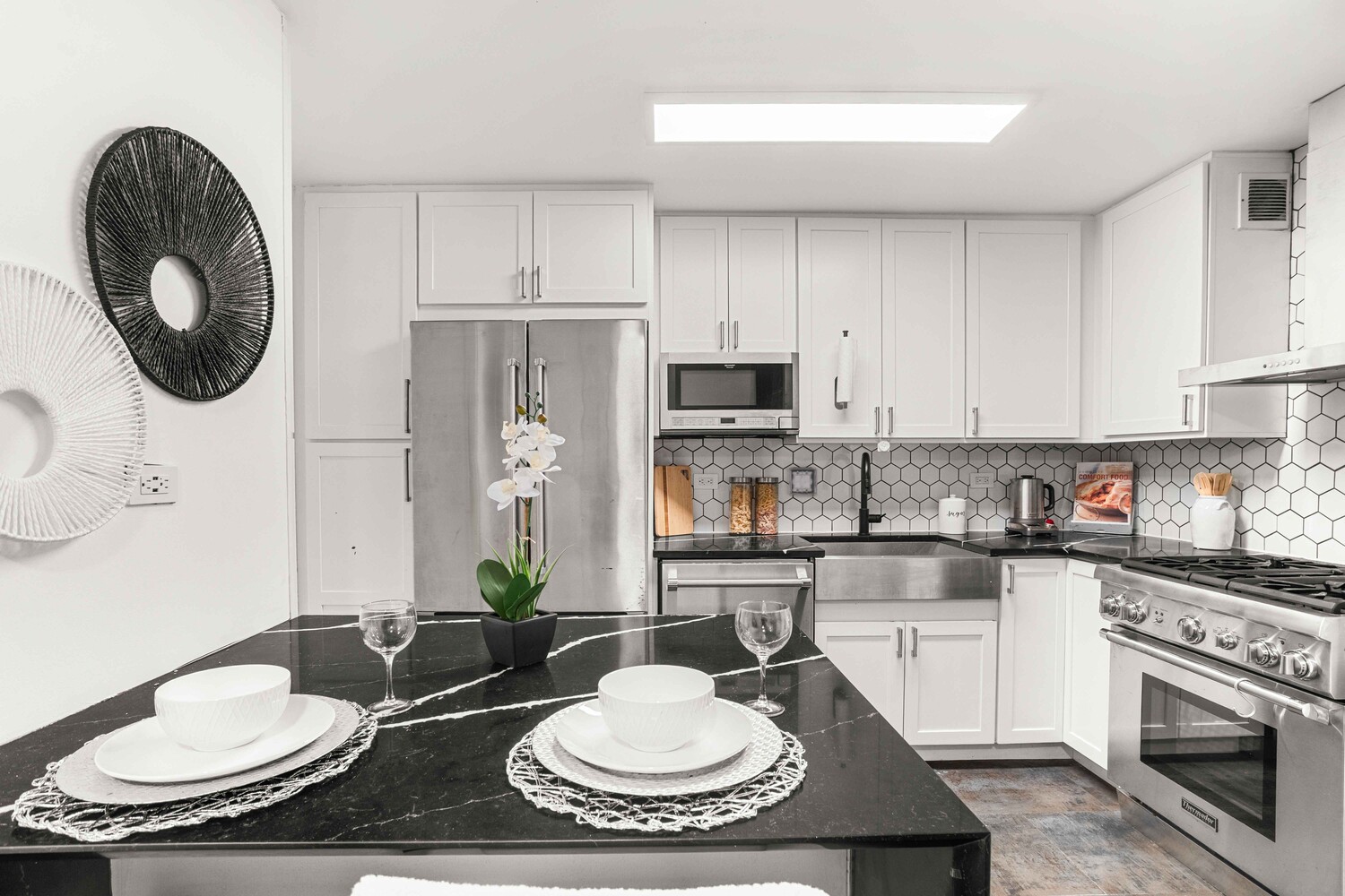 225 East 86th Street, Unit 204 Manhattan, NY 10028 - Photo 8 of 17 a kitchen with stainless steel appliances a sink a stove a table and chairs