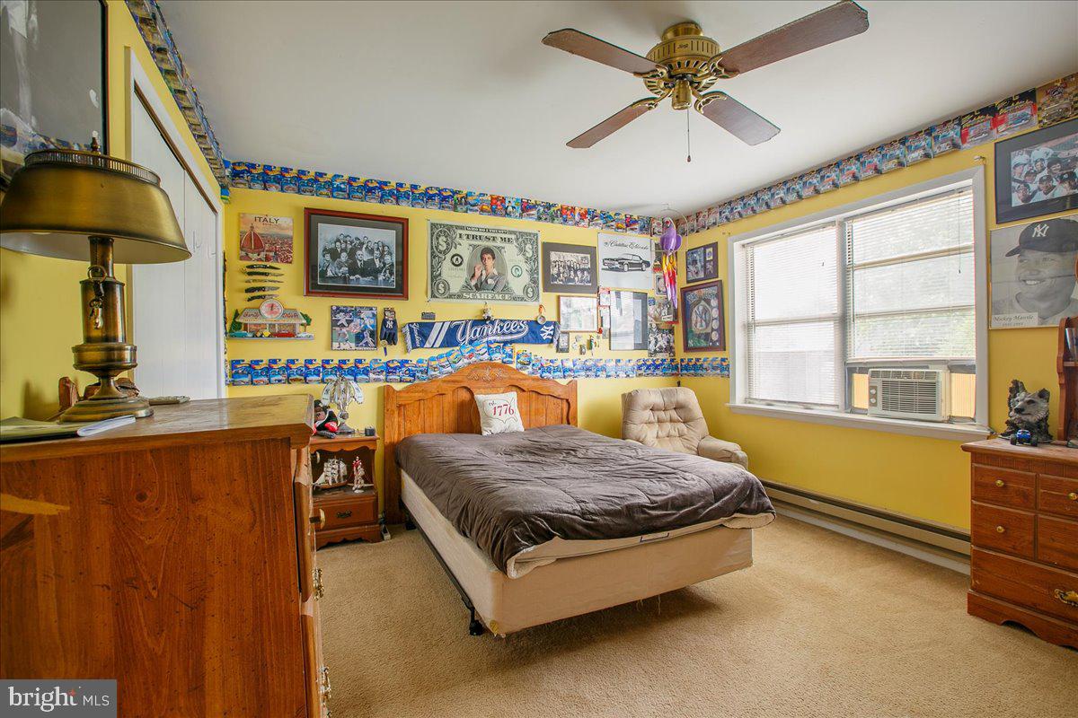 3 Winding Way Lititz, PA 17543 - Photo 20 of 34 a spacious bedroom with a bed and a chandelier