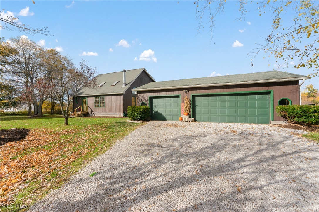 5511 Monroe Center Road Conneaut, OH 44030 - Photo 26 of 39 Salt Box Style Home featuring a front lawn and a garage and large driveway.