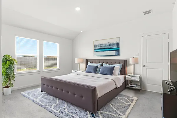 a bedroom with a large bed and a window