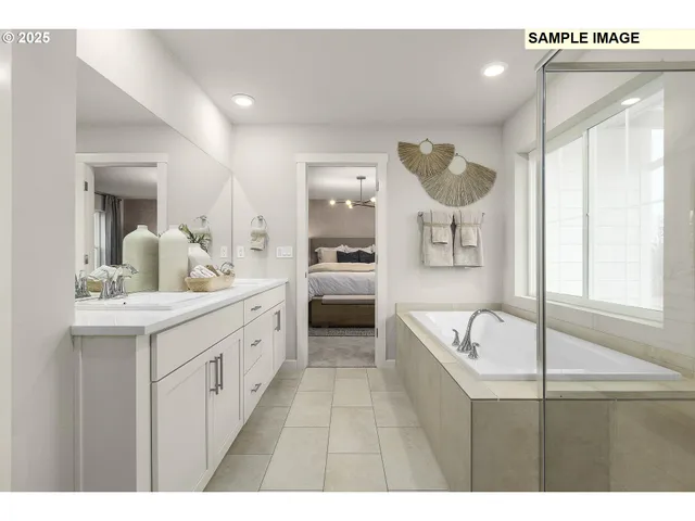 a large bathroom with a double vanity sink a bathtub a mirror and vanity