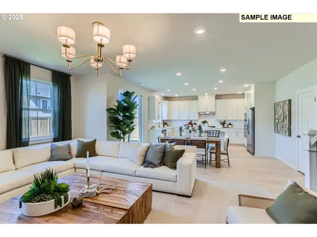 a living room with furniture kitchen view and a chandelier