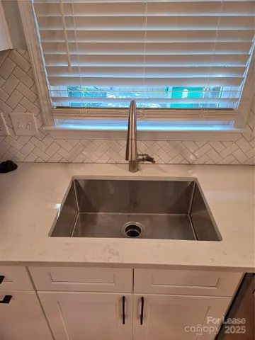 a kitchen with stainless steel appliances granite countertop a granite counter tops and a wooden floors