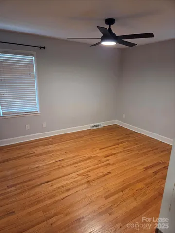 a view of a closet with wooden floor
