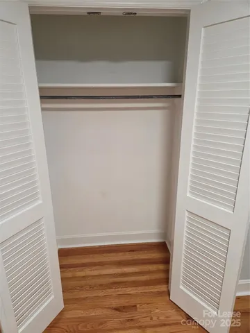 a bathroom with a granite countertop toilet and a sink