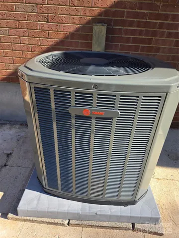 a view of a backyard with floor to ceiling window and wooden fence