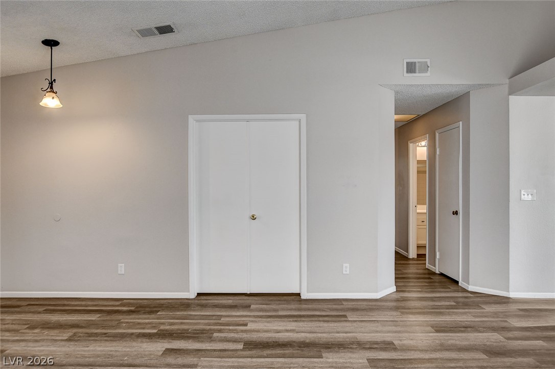 6209 Warm River Road Las Vegas, NV 89108 - Photo 20 of 39 An inviting room features high vaulted ceilings and durable wood-look flooring.