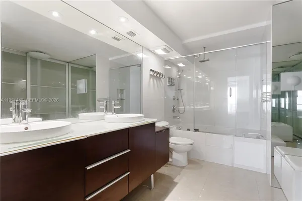 a bedroom with a balcony a bed and a chandelier