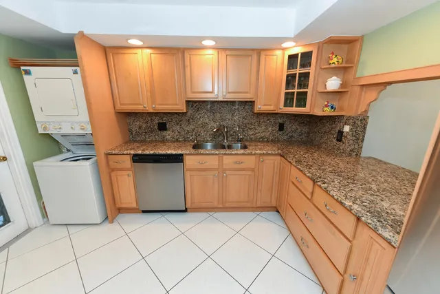 a kitchen with stainless steel appliances granite countertop a sink and a stove