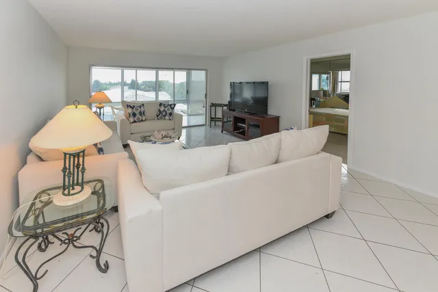 a living room with furniture a table and a window