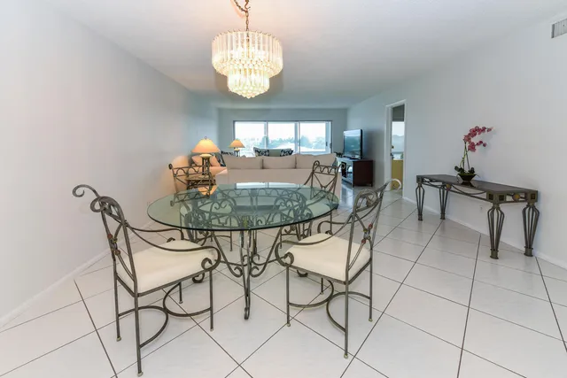a view of a dining room with furniture a chandelier and wooden floor