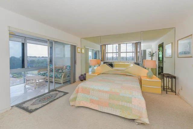 a bedroom with a bed and a large window