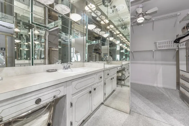 a spacious bathroom with a sink a mirror and a shower