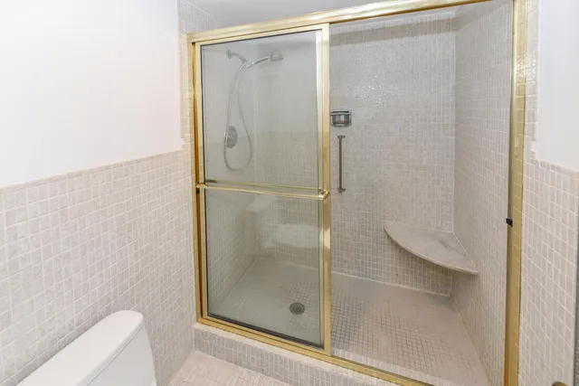 a bathroom with a glass shower door