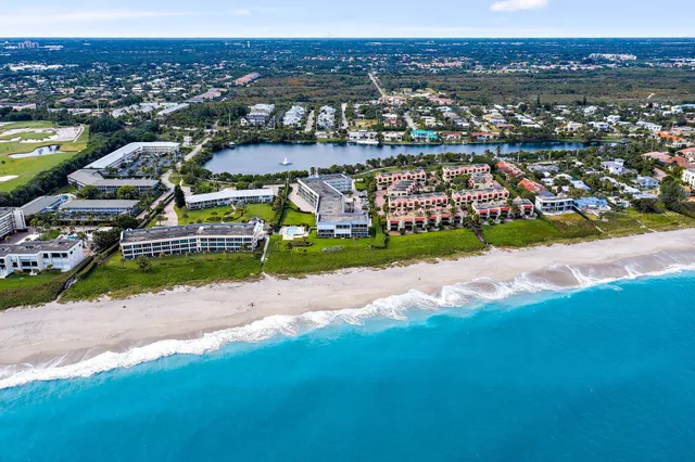 an aerial view of a house with a lake view