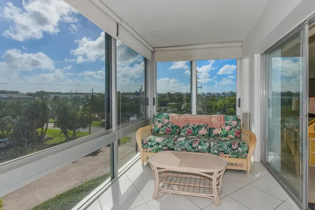 a wooden bench sitting in front of a building