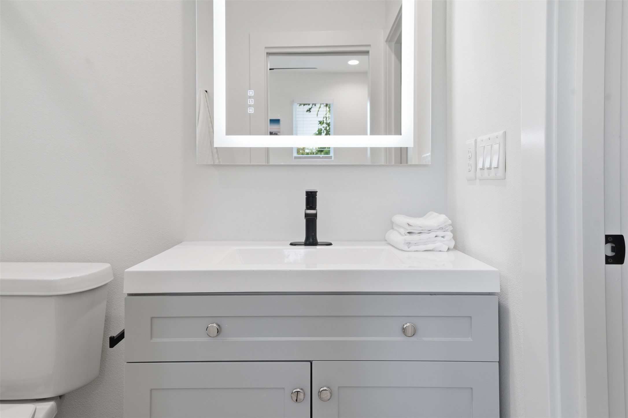 2216 Yellow Jacket Lane, Unit 2 Austin, TX 78741 - Photo 18 of 25 a bathroom with a sink a toilet and mirror