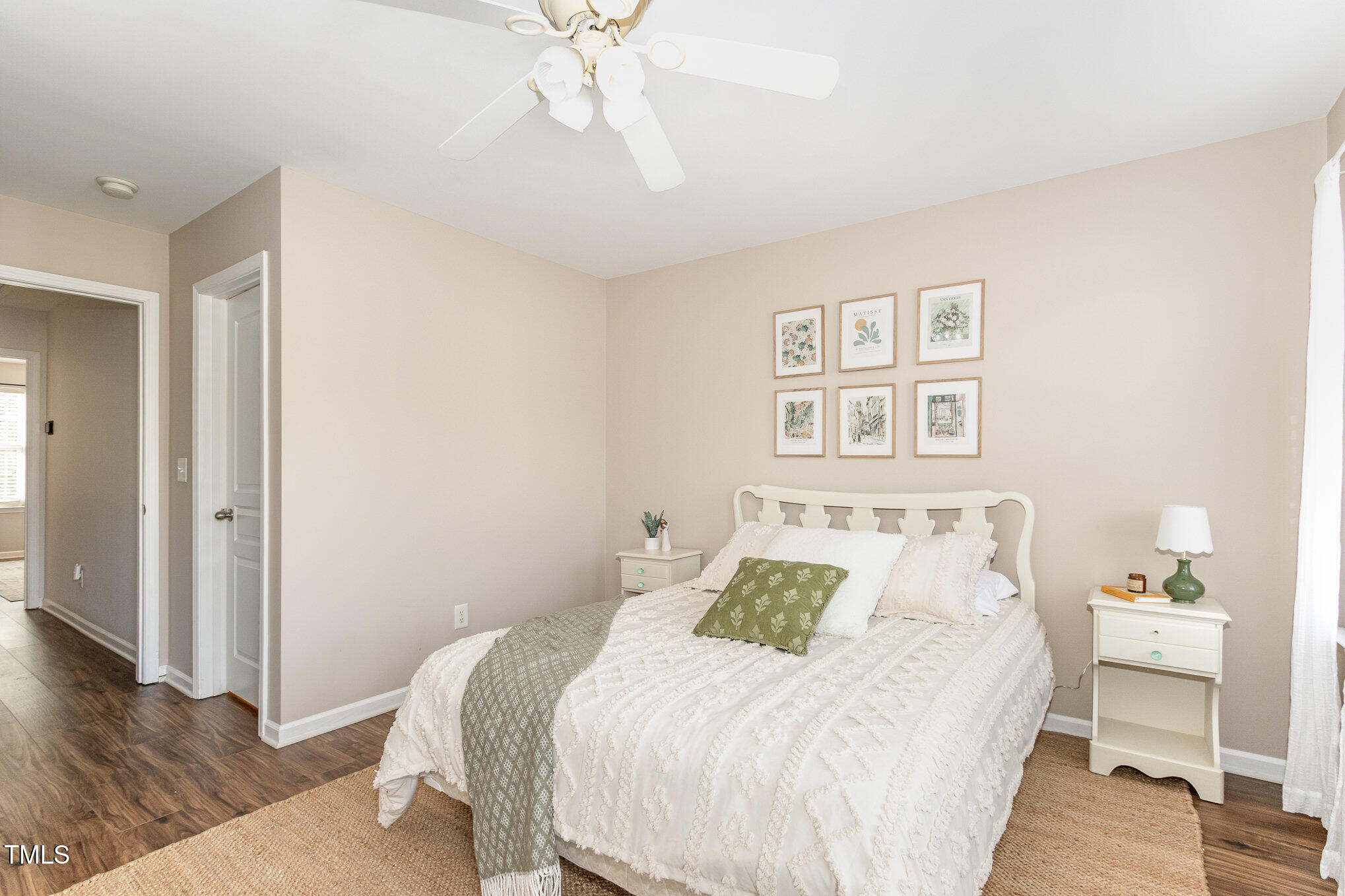7621 Satinwing Lane Raleigh, NC 27617 - Photo 16 of 23 a bedroom with a bed and wooden floor