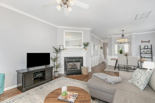 a living room with furniture a flat screen tv and a fireplace