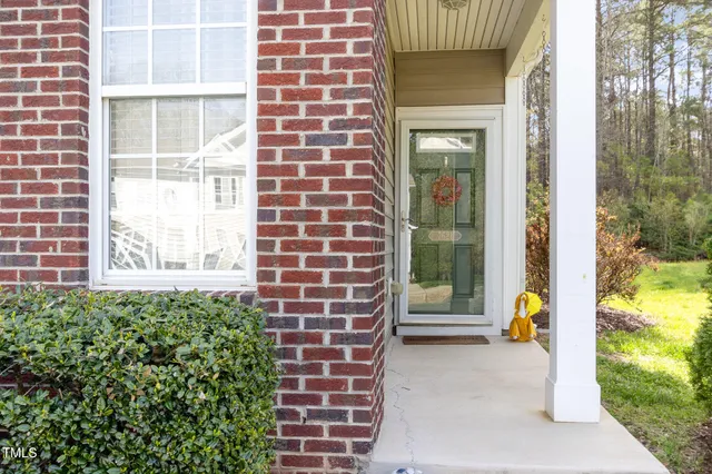a view of a brick house with a large windows
