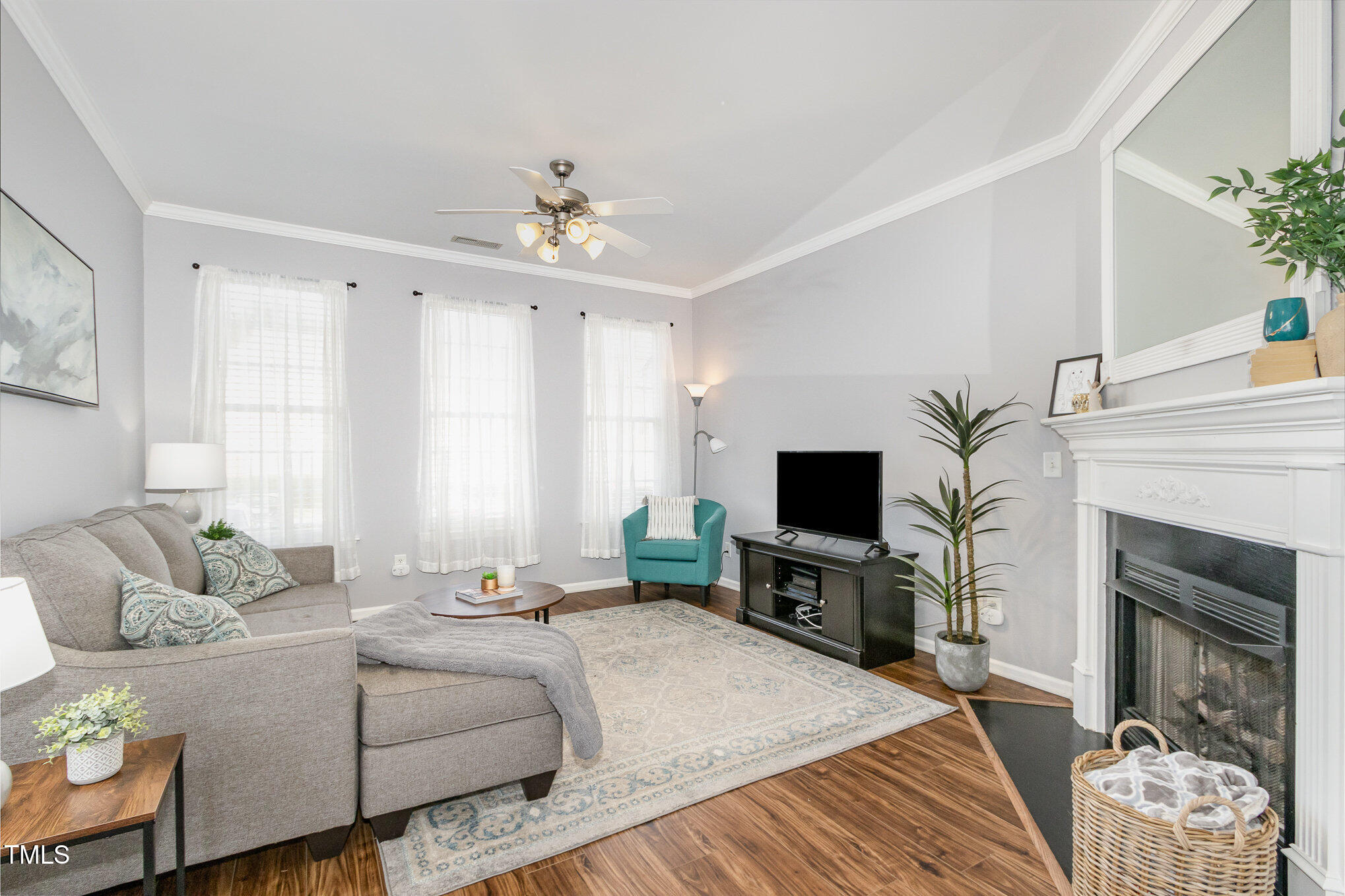 7621 Satinwing Lane Raleigh, NC 27617 - Photo 4 of 23 a bedroom with a bed a flat screen tv and a fireplace