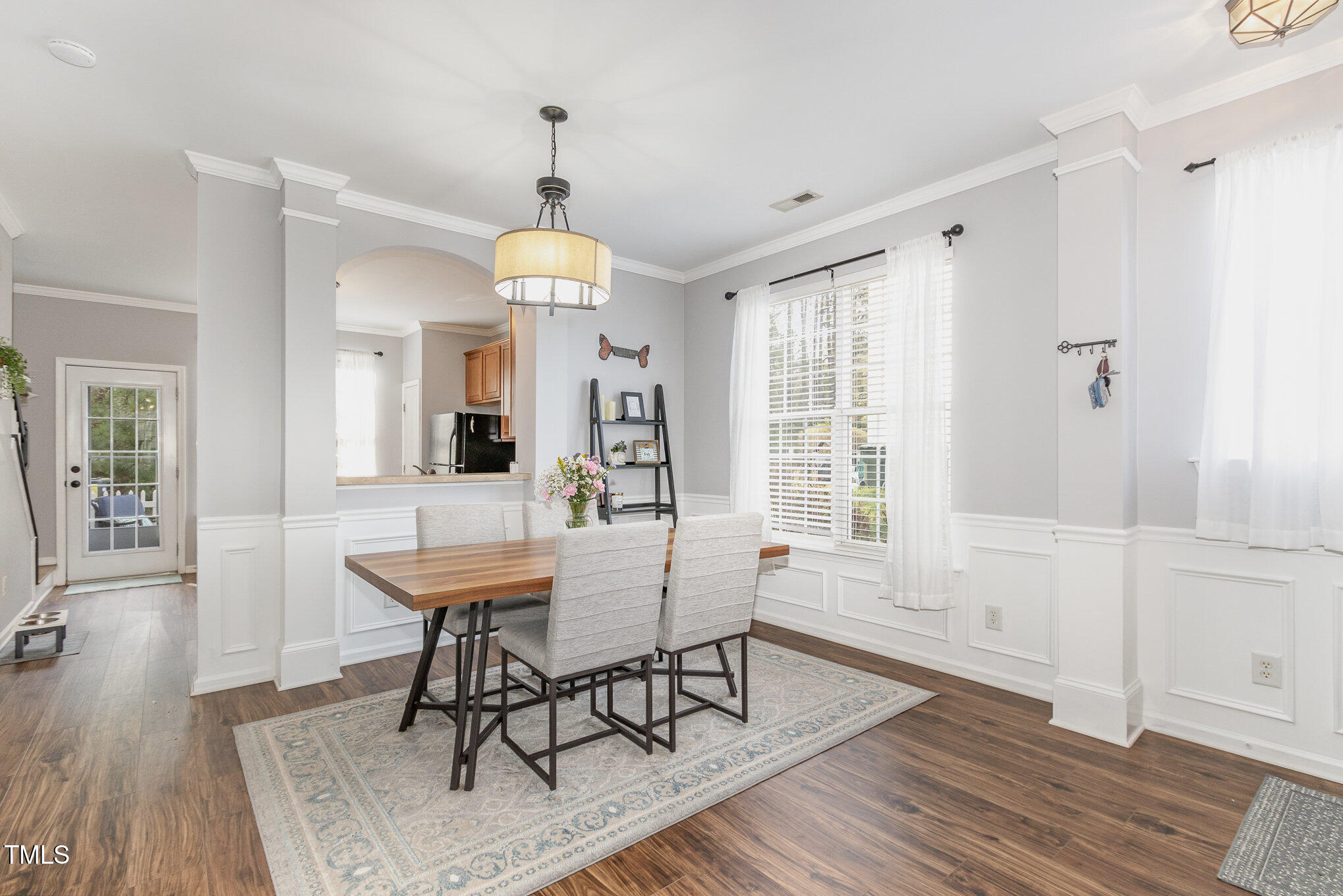 7621 Satinwing Lane Raleigh, NC 27617 - Photo 5 of 23 a view of a a dining room with furniture window and wooden floor