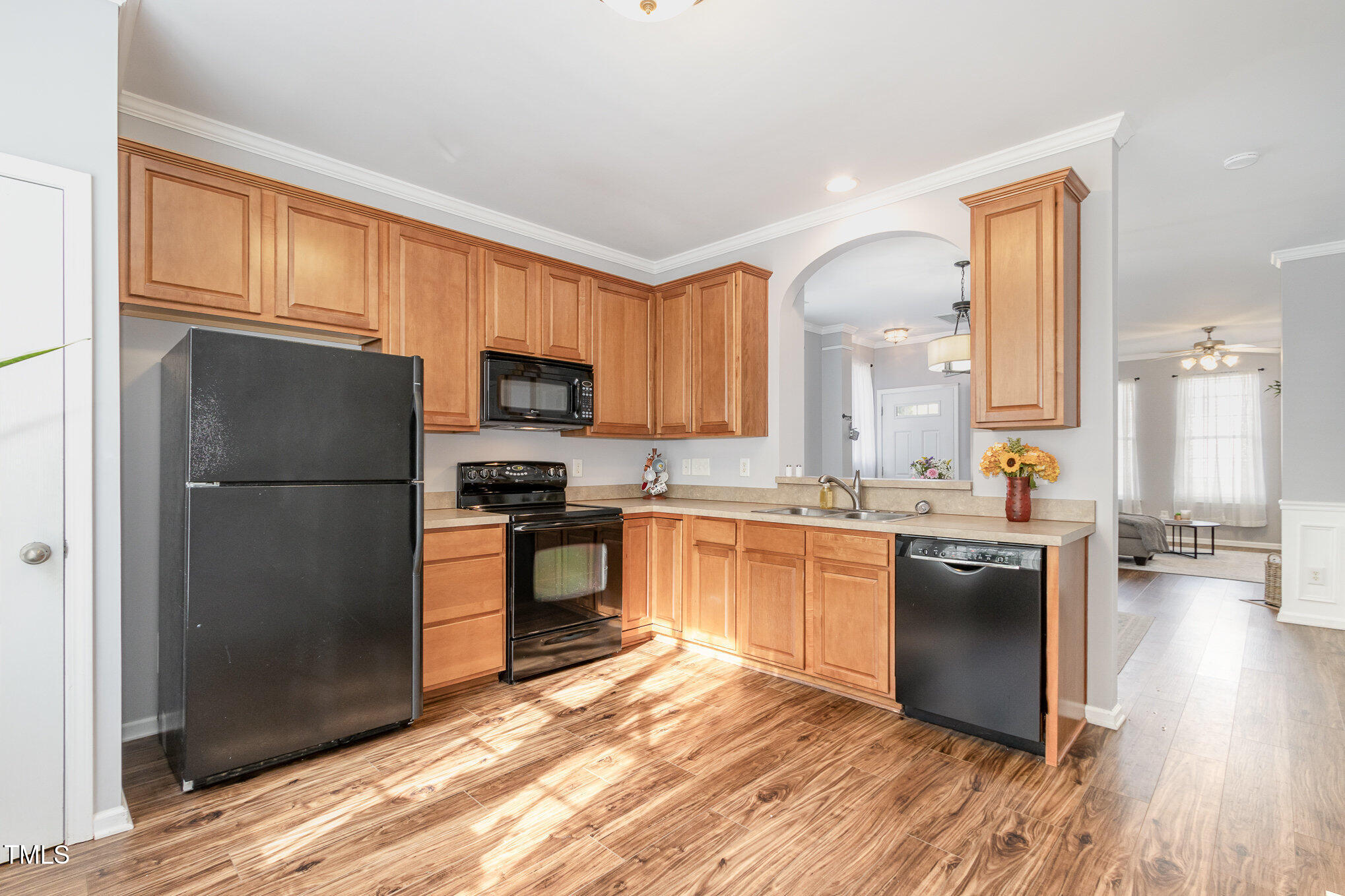 7621 Satinwing Lane Raleigh, NC 27617 - Photo 7 of 23 a kitchen with granite countertop stainless steel appliances a refrigerator cabinets and wooden floor