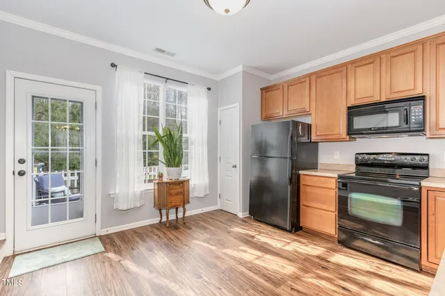 a kitchen with stainless steel appliances granite countertop a refrigerator stove microwave and sink