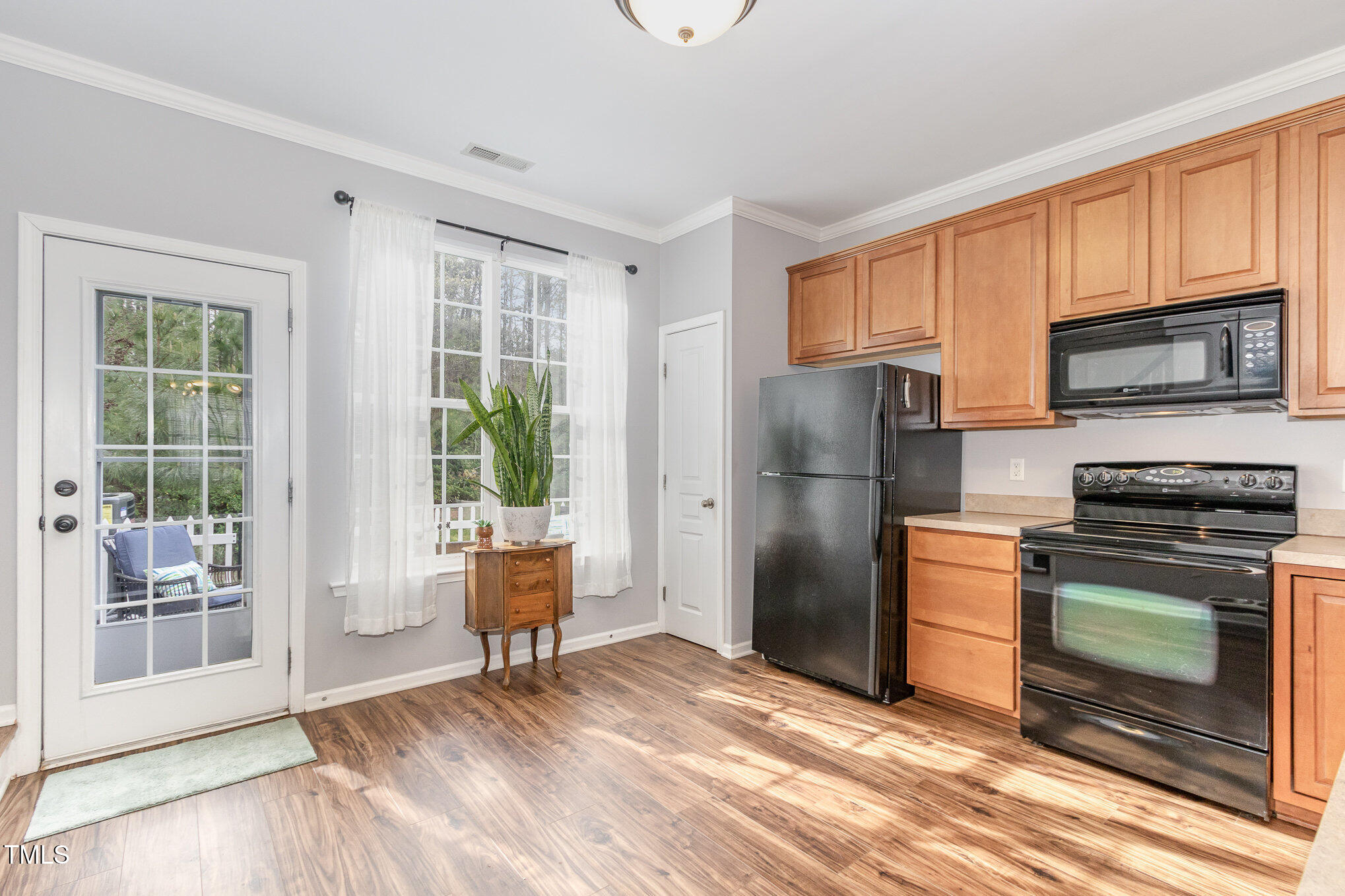 7621 Satinwing Lane Raleigh, NC 27617 - Photo 8 of 23 a kitchen with stainless steel appliances granite countertop a refrigerator stove microwave and sink