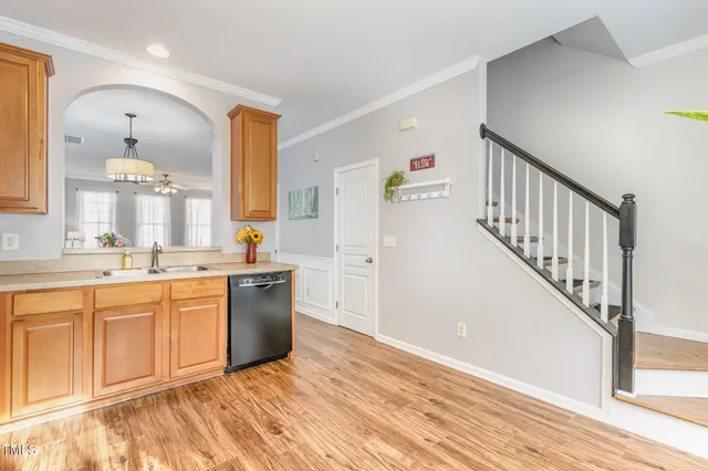a kitchen with granite countertop a sink stove and cabinets